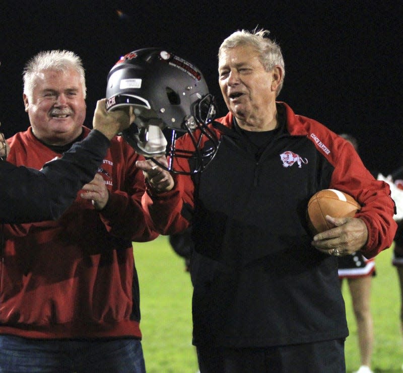 Manchester football coach Jim France is presented a game ball and helmet after winning his 382nd game on Oct. 27, 2017, at James R. France Stadium.