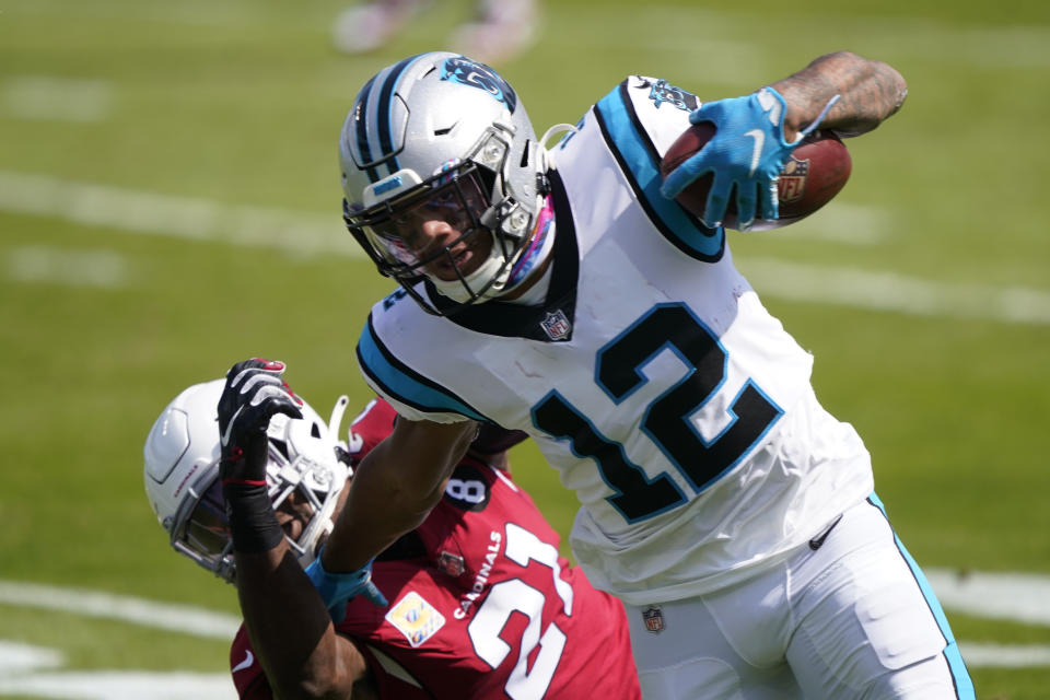 Carolina Panthers wide receiver D.J. Moore runs pass Arizona Cardinals cornerback Patrick Peterson during the first half of an NFL football game Sunday, Oct. 4, 2020, in Charlotte, N.C. (AP Photo/Brian Blanco)
