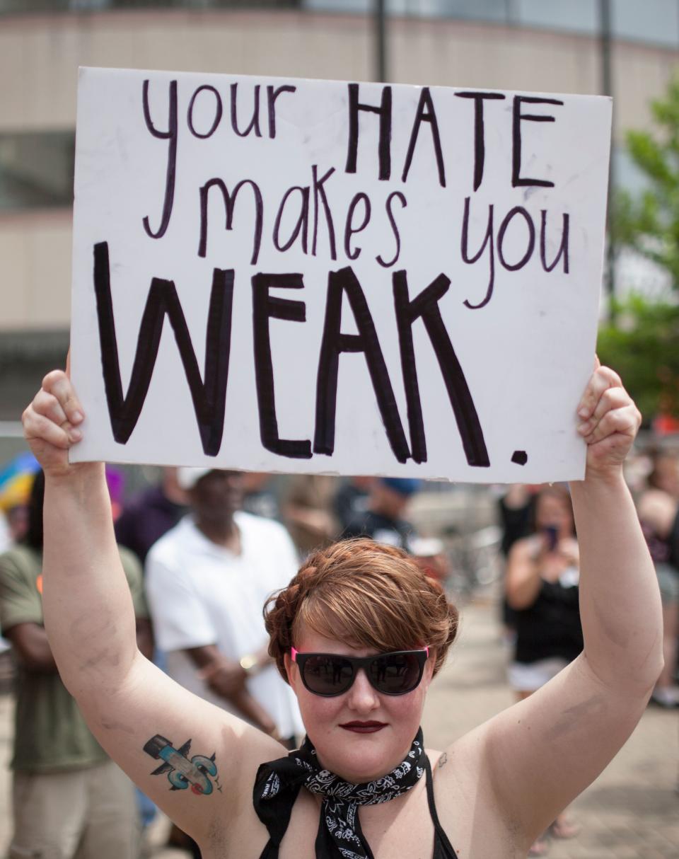 An anti-Klan protestor holds a sign at a small rally of a KKK-affiliated group that gathered in Dayton, Ohio, on May 25, 2019. | SETH HERALD—AFP/Getty Images