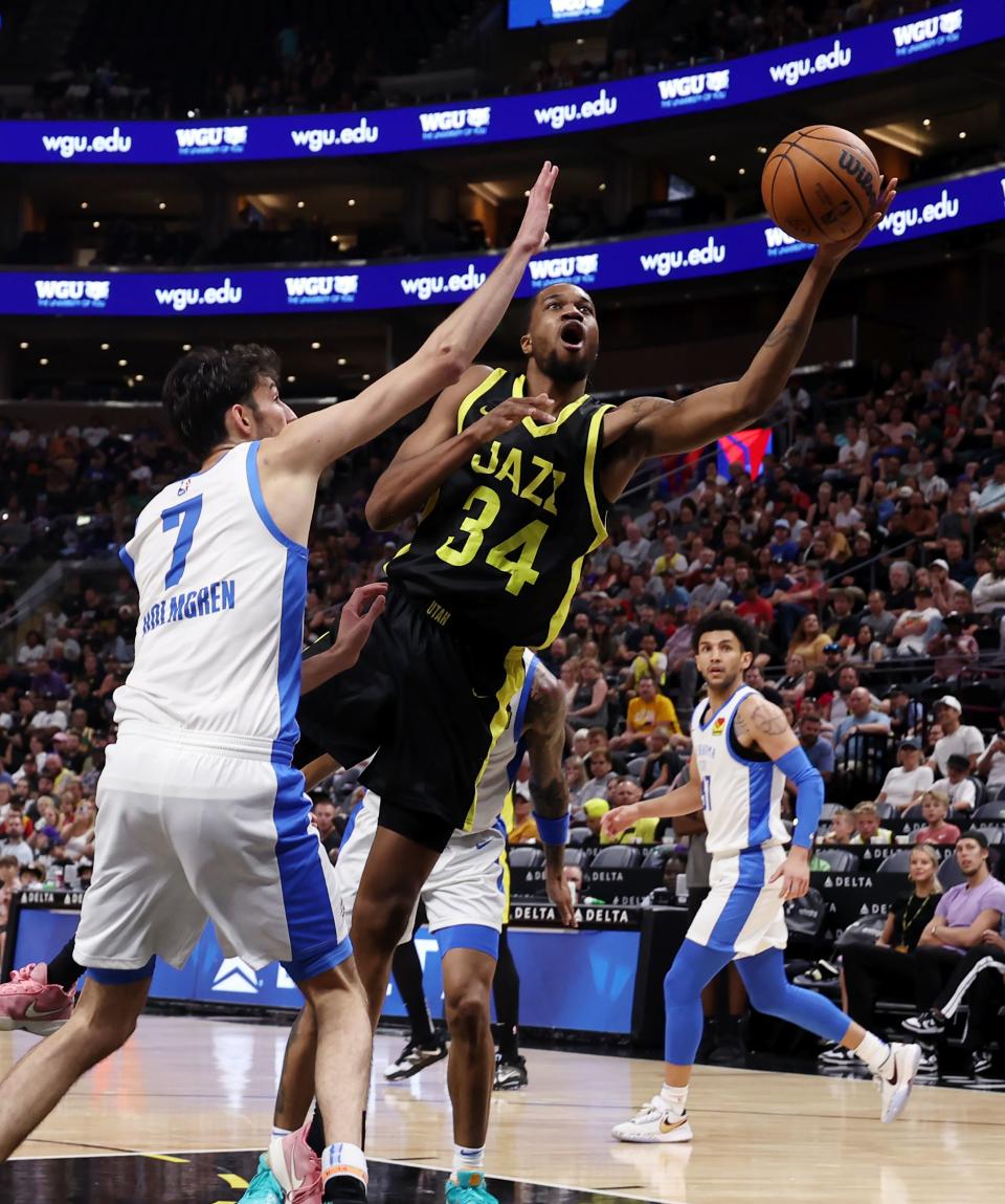 Utah Jazz’s Nick Ongenda slices past and Oklahoma City Thunder’s Chet Homgren for a shot as they play in Summer League action at the Delta Center in Salt Lake City on Monday, July 3, 2023. Jazz lose 95-85. | Scott G Winterton, Deseret News