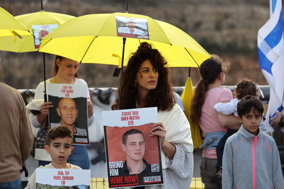 A woman holds the image of 22-year-old Omer Neutra as relatives, friends and supporters of Israeli hostages held in the Gaza Strip as they march towards Jerusalem on Nov. 17.