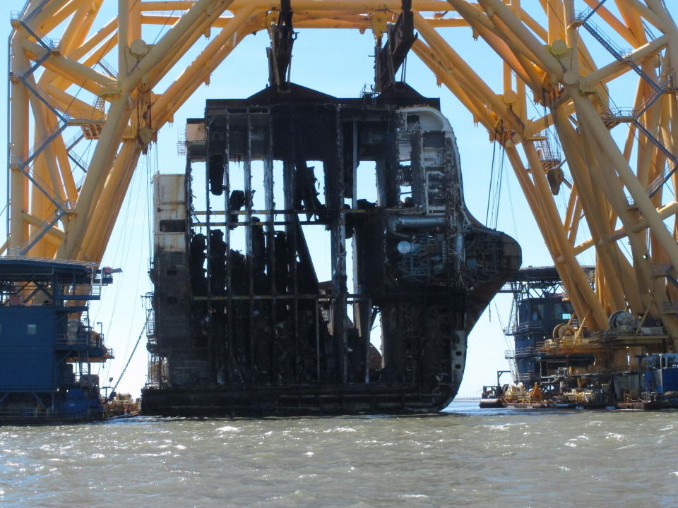 FILE - In this April 26, 2021 file photo, interior decks of the capsized cargo ship Golden Ray are exposed after the engine room section was cut away and separated from the rest of the shipwreck by a towering crane, offshore of St. Simons Island, Ga. Accounts contained in crew member interviews are among more than 1,700 pages of documents made public Thursday, July 29, by the National Transportation Safety Board. The Golden Ray, carrying more than 1,400 vehicles, overturned after leaving the Port of Brunswick along the Georgia coast on Sept. 8, 2019. Tennant and about two dozen crew members on board were rescued and survived. (AP Photo/Russ Bynum, File)