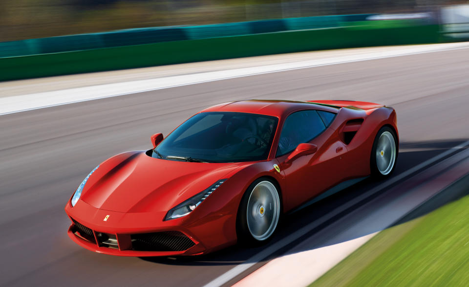 A red Ferrari 488 GTB, a mid-engined exotic sports car, shown at speed on a race track