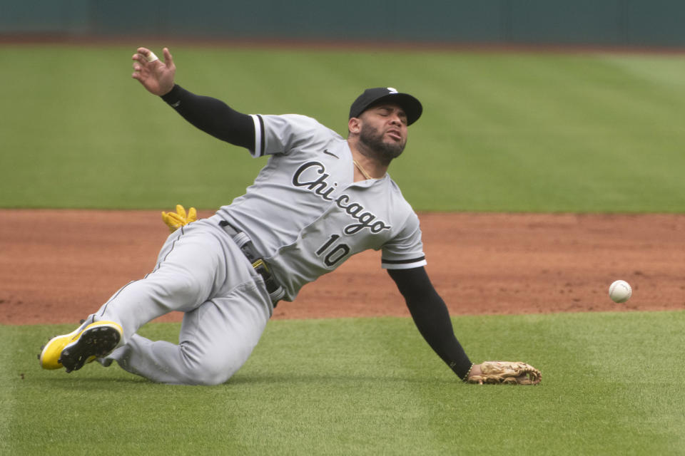 Chicago White Sox' Yoan Moncada falls and misses an infield fly by Cleveland Guardians' Andres Gimenez during the first inning of a baseball game in Cleveland, Sunday, Aug. 6, 2023. (AP Photo/Phil Long)