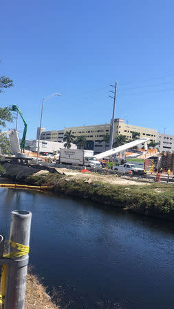Emergency crews work at the scene of a collapsed pedestrian bridge at Florida International University in Miami, Florida, U.S., March 15, 2018 in this image obtained from social media. Instagram/ @barbituriinsua via REUTERS