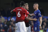 ManU defender Luke Shaw, center and Paul Pogba argue with Chelsea's Ross Barkley, right, after he scored his side's second goal during their English Premier League soccer match between Chelsea and Manchester United at Stamford Bridge stadium in London Saturday, Oct. 20, 2018. (AP Photo/Matt Dunham)