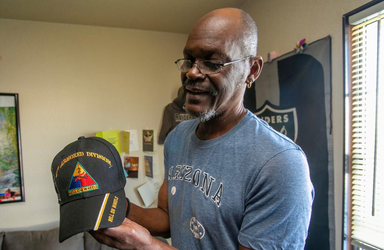 Teddy Henderson, of Sheboygan, holds a hat that displays the division he was in the armed forces, Tuesday, March 14, 2023, at his home in Sheboygan, Wis. Henderson went through veterans court recently.