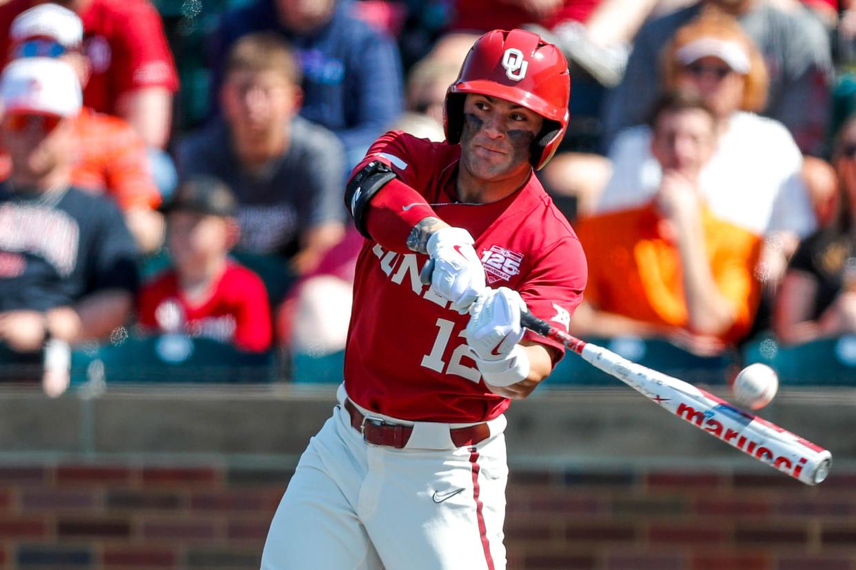 Oklahoma outfielder Bryce Madron (12) hits a foul ball during the Bedlam baseball game between the Oklahoma Sooners and the Oklahoma State Cowboys at L. Dale Mitchell Park in Norman, Okla., on Saturday, May 20, 2023.