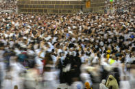 In this photo taken with low shutter speed, Muslim pilgrims circumambulate around the Kaaba, the cubic building at the Grand Mosque, in Mecca, Saudi Arabia, Wednesday, July 6, 2022. Muslim pilgrims are converging on Saudi Arabia's holy city of Mecca for the largest hajj since the coronavirus pandemic severely curtailed access to one of Islam's five pillars. (AP Photo/Amr Nabil)