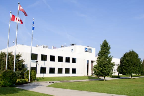 General Motors CAMI Assembly Plant in Ingersoll, Ontario, a white building with a green lawn in front.