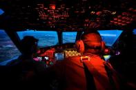 Crew members on board an RAAF AP-3C Orion during a search mission for missing flight MH370 before, March 24, 2014
