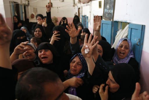 Relatives of Palestinian Hisham Abu Harb mourn during his funeral in Rafah in the southern Gaza Strip. A truce announced by Gaza militants appeared to be fast unravelling after 11 Palestinians were killed in seven Israeli air strikes in under 48 hours