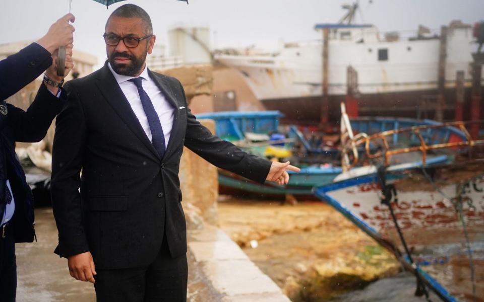 James Cleverly, Home Secretary, views a sunken boat used to cross from Africa, during a visit to Lampedusa to learn about how the Guardia di Finanza police tackle migration, on April 24