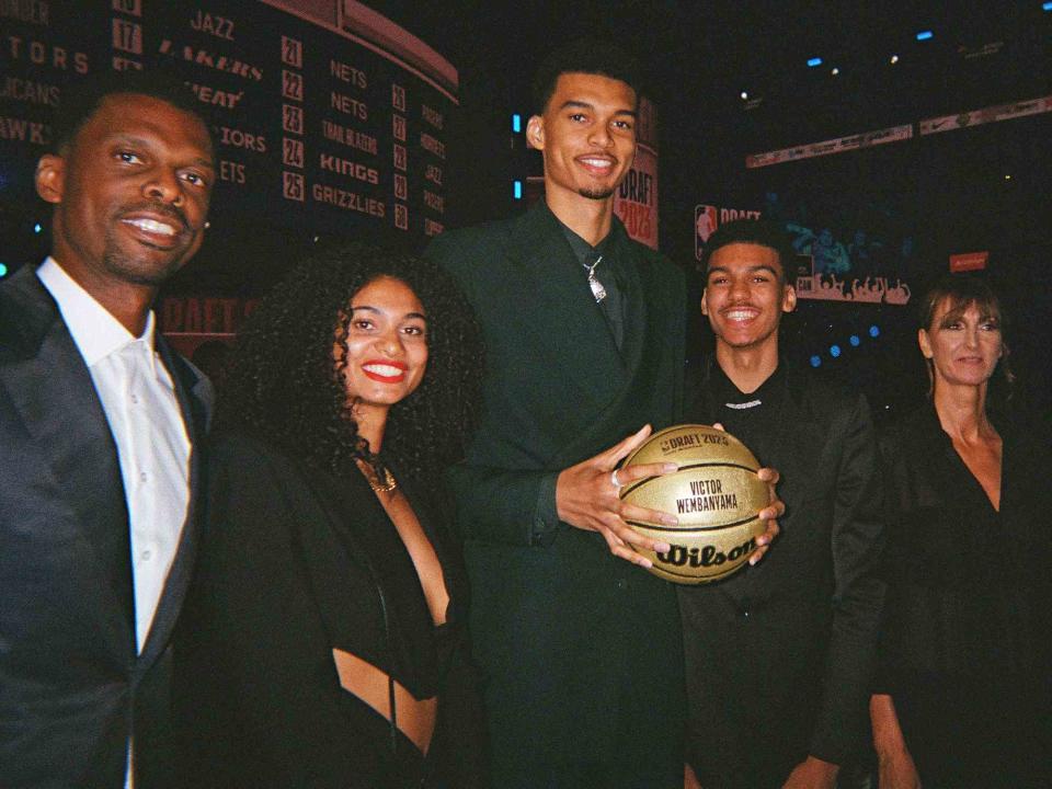 <p>Jenny Fischer/NBAE/Getty </p> Victor Wembanyama poses for a photograph with family during the 2023 NBA Draft on June 22, 2023 at Barclays Center in Brooklyn, New York. 
