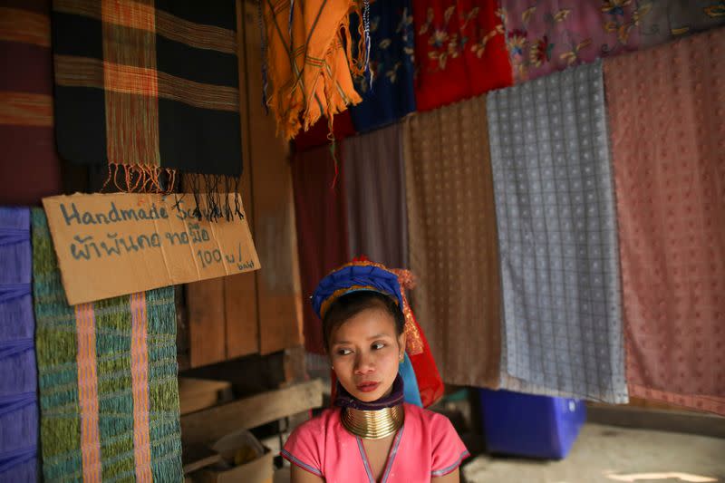 A woman sells clothes in the Kayan village where people, who fled from Myanmar during the 1990s war between Myanmar's army and ethnic army groups, live in Mae Hong Son