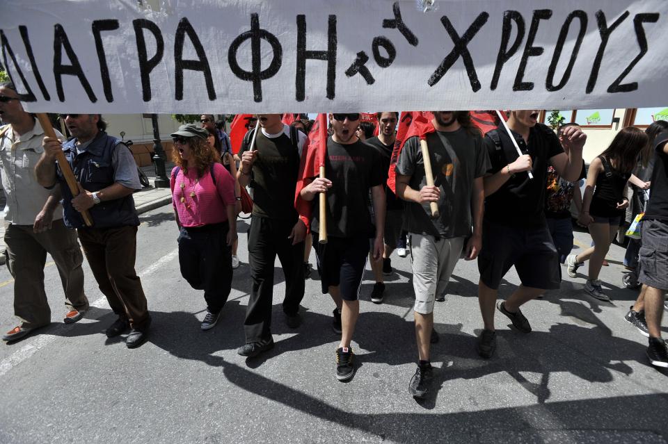 Protesters hold a banner that reads: ''Debt write-off'', during a May Day protest in the northern Greek port city of Thessaloniki, Greece, Tuesday, May 1, 2012. In debt-crippled Greece, more than 8,000 people marched through Thessaloniki in subdued May Day protests centered on the country's harsh austerity program. (AP Photo/Nikolas Giakoumidis)