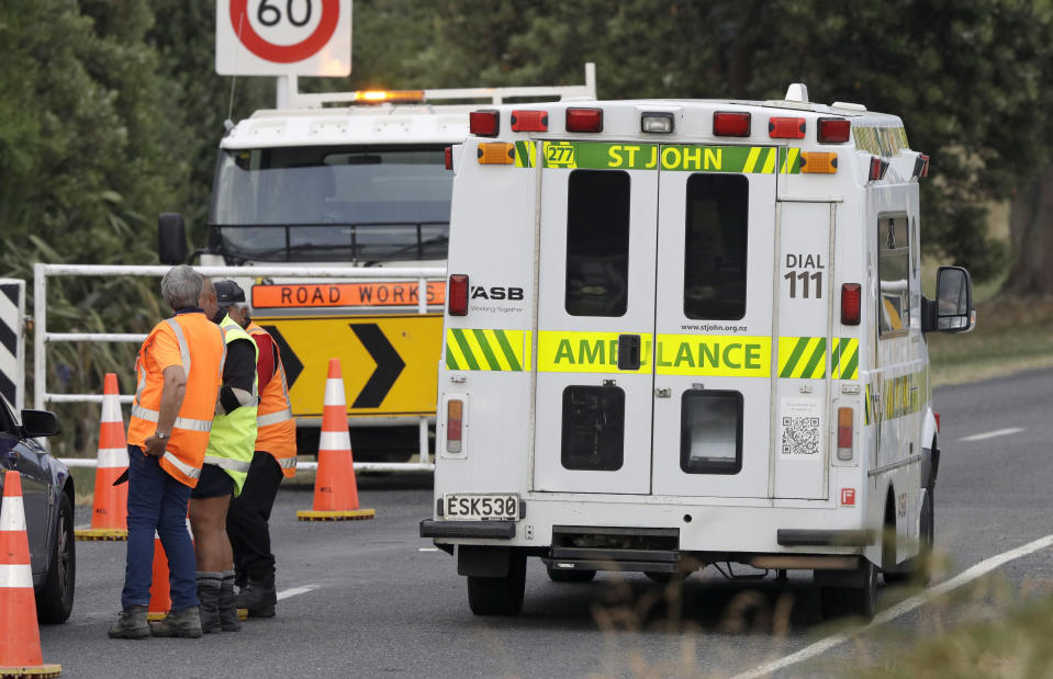 A ambulance arrives at Whakatane Airport, as the recovery operation to return the victims of the Dec. 9 volcano eruption continues off the coast of Whakatane New Zealand, Friday, Dec. 13, 2019. A team of eight New Zealand military specialists landed on White Island early Friday to retrieve the bodies of victims after the Dec. 9 eruption. (AP Photo/Mark Baker)
