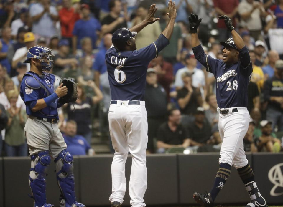 Milwaukee Brewers' Curtis Granderson is congratulated by Lorenzo Cain after hitting a two-run home run during the seventh inning of a baseball game against the Chicago Cubs Wednesday, Sept. 5, 2018, in Milwaukee. (AP Photo/Morry Gash)