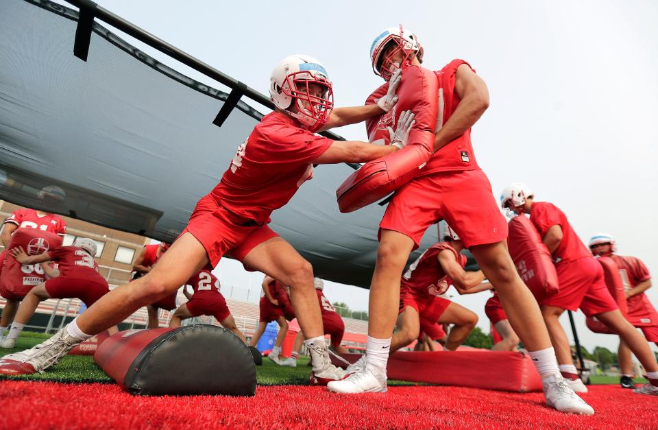 Kimberly High School football players Brody Beck, left, and Braedon Ellefson battle during the Papermakers’ first practice of the season Tuesday in Kimberly.