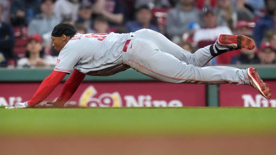 Cincinnati Reds' Will Benson dives into third on a triple during the fourth inning of a baseball game against the Boston Red Sox at Fenway Park, Tuesday, May 30, 2023, in Boston.