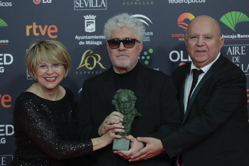 Spanish film director Pedro Almodovar, center, and producers Agustin Almodovar and Esther Garcia, left, pose with their trophy after winning the best film award for "Dolor y gloria" during the Goya Film Awards Ceremony in Malaga, southern Spain, early Sunday, Jan. 26, 2020. The annual Goya Awards are Spain's main national film awards. (AP Photo/Manu Fernandez)