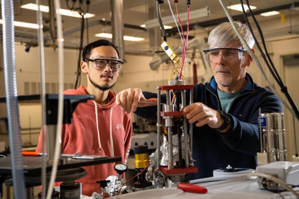 Chemist Janos Szanyi (right) led a team of researchers that included Linxiao Chen in discovering a promising approach to make it easier to turn petroleum-based plastic waste into chemicals that can be used to produce new materials and fuels. Andrea Starr/Pacific Northwest National Laboratory