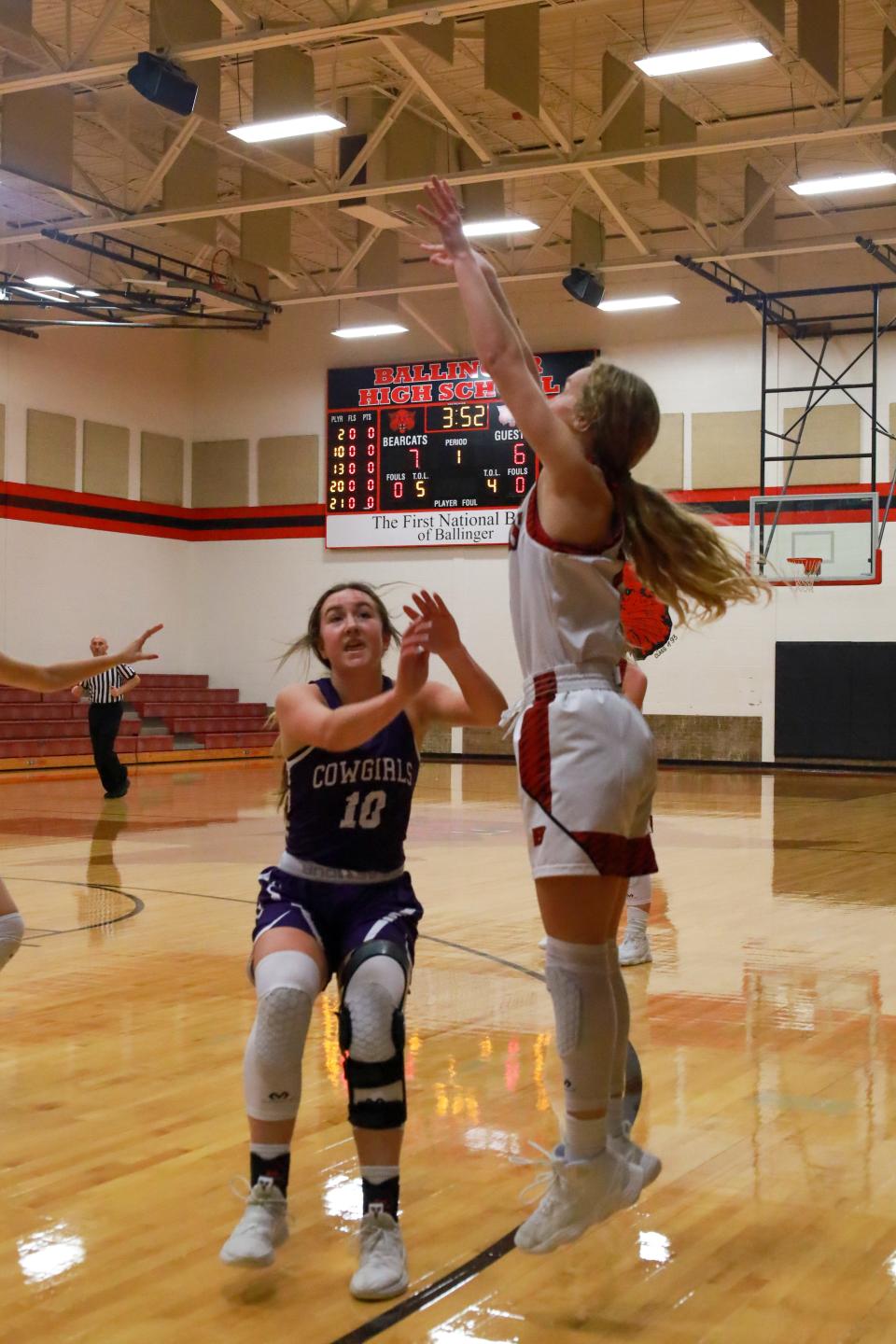 Ballinger's Skyla Hostetter fires a 3-pointer as Mason's Sterling Smith closes in during their basketball game Tuesday, Dec. 7, 2021.