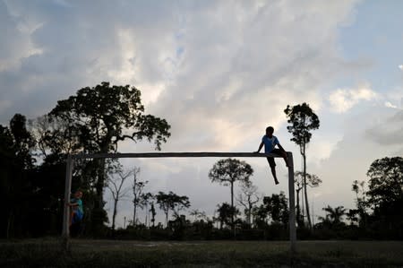 Children play on a soccer field at Esperanca PDS, a sustainable settlement project in Anapu