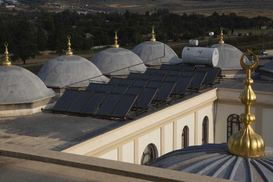 Solar panels work on the roof of the Nizamiye Mosque in Johannesburg, South Africa, Wednesday, April 5, 2023. The more than 140 panels cover over a third of the complex's energy use in a country that has struggled in recent years to provide enough electricity through its strained grid. (AP Photo/Denis Farrell)