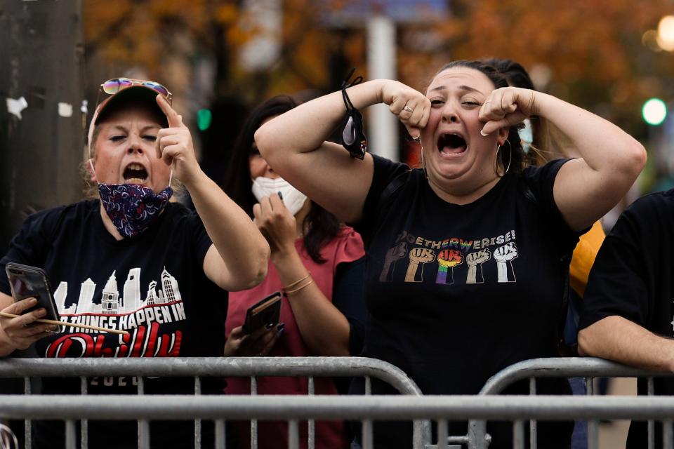 Joe Biden fans taunt Trump supporters in Washington, but the outgoing president could make moves which appeal to his base before he leaves office (AP Photo/Rebecca Blackwell)AP
