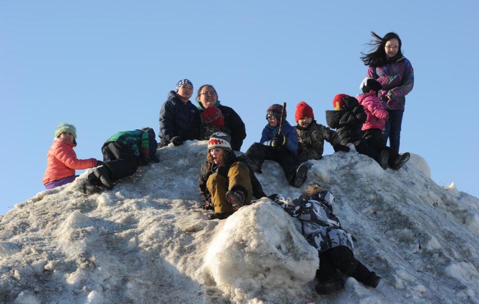 Race fans wait for Aliy Zirkle to drive her dog team into the Unalakleet checkpoint. Zirkle is the first musher to reach the Bering Sea in Unalakleet during the 2014 Iditarod Trail Sled Dog Race on Saturday, March 8, 2014. (AP Photo/The Anchorage Daily News, Bob Hallinen)