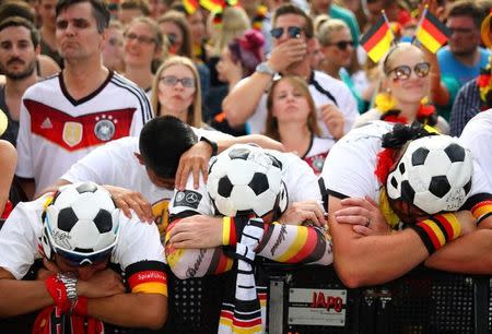 Soccer Football - World Cup - Group F - South Korea v Germany - Berlin, Germany - June 27, 2018 - Germany fans react as they watch the match at a public viewing area at Brandenburg Gate. REUTERS/Hannibal Hanschke