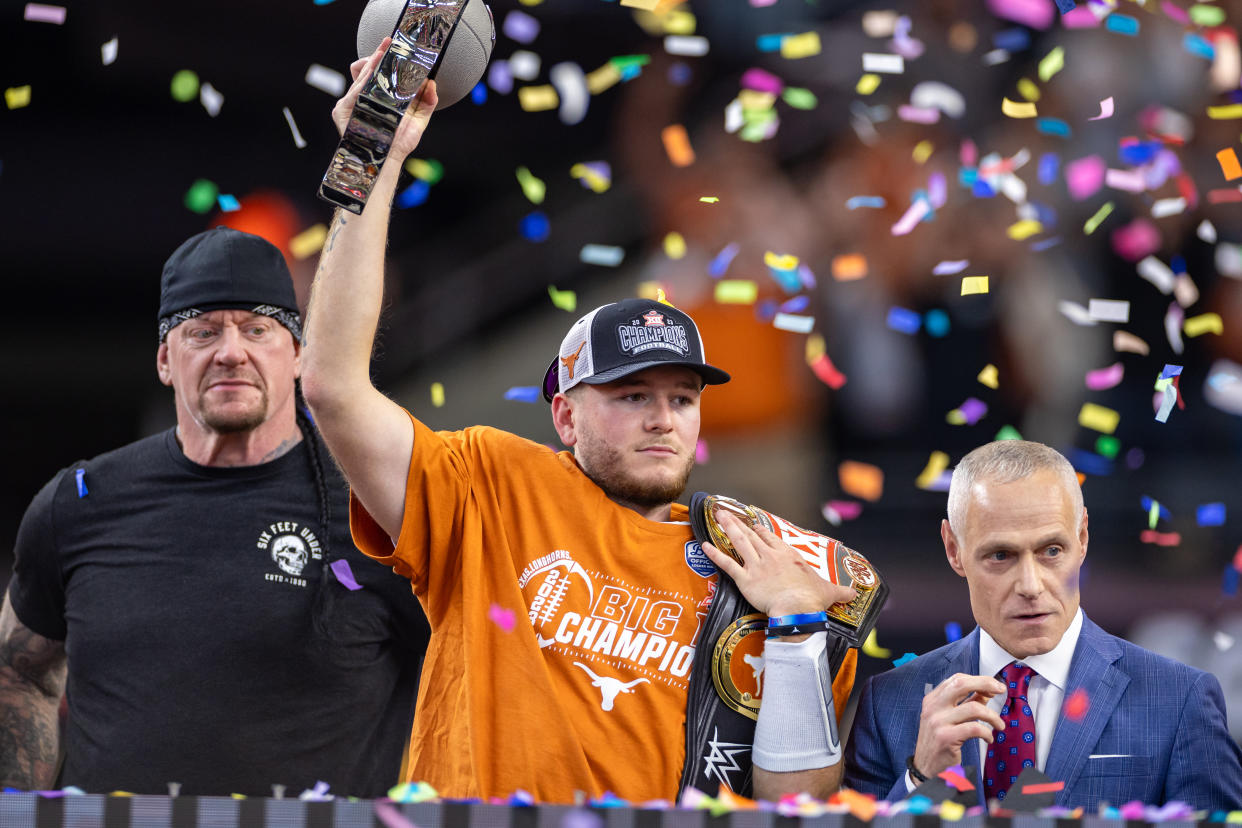 ARLINGTON, TX - DECEMBER 02: Texas Longhorns quarterback Quinn Ewers (#3) lifts the Big 12 championship trophy during the Big 12 Championship football game between the Texas Longhorns and Oklahoma State Cowboys on December 02, 2023 at AT&T Studium in Arlington, Texas. (Photo by Matthew Visinsky/Icon Sportswire via Getty Images)