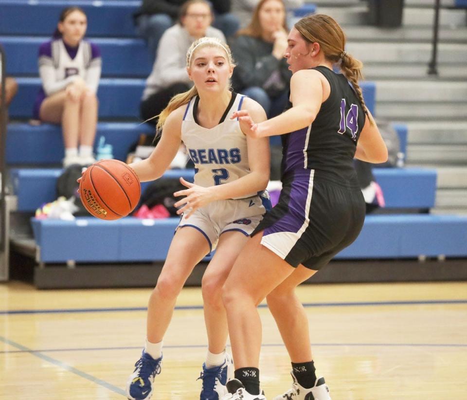 Danville’s Taylor Moore drives the baseline guarded by Burlington’s Ella Schroeder.