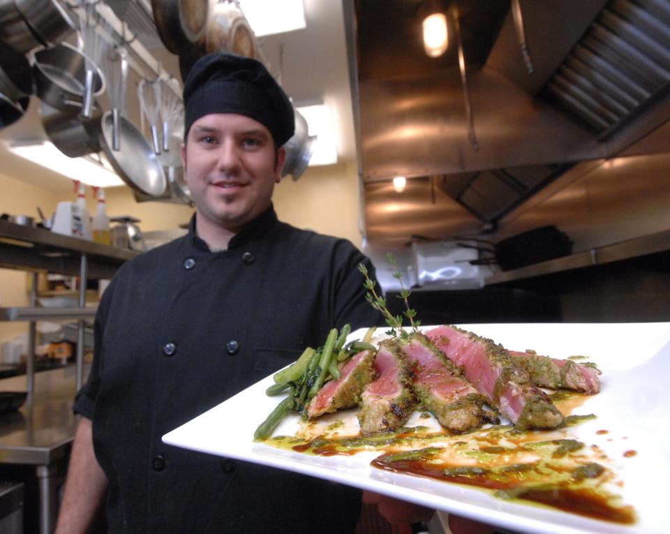 Executive Chef Travis Teska holds a plate of wasabi-encrusted ahi tuna in June 2007 at The Wright Place on 6th in Wausau. The restaurant opened in September 2006 and operated until 2012 in the historic Ely Wright House.