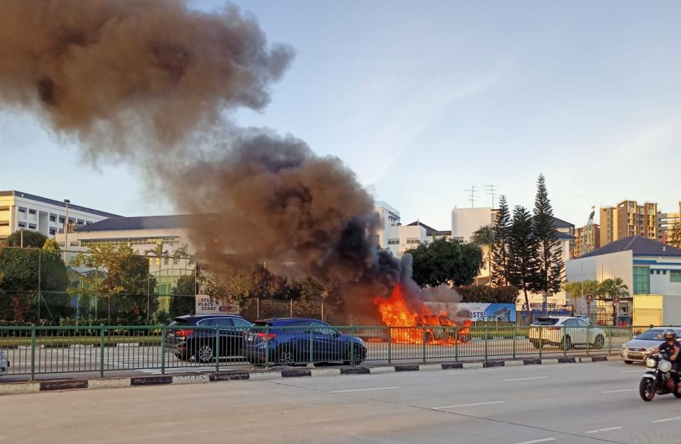 A car in flames near Maris Stella High School on 13 January 2022. (PHOTO: Courtesy of Wong Min Hao/Yahoo News Singapore)