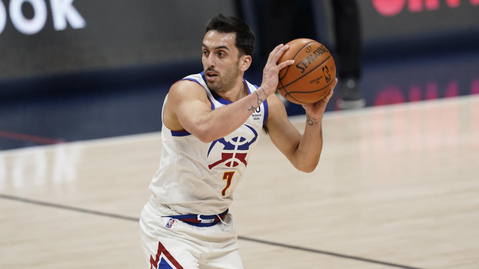 Facundo Campazzo holds the ball in his hands as he looks for an open teammate.