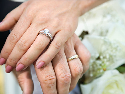 bride and groom holding hands