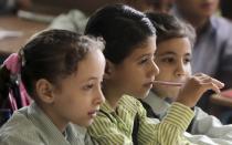 Students attend a class on the first day of their new school year at a government school in Giza, south of Cairo September 22, 2013. Students resumed their studies at the beginning of the new academic year this weekend amid parental concerns of a possible lack of security after the summer vacation ends. REUTERS/Mohamed Abd El Ghany (EGYPT - Tags: POLITICS EDUCATION)