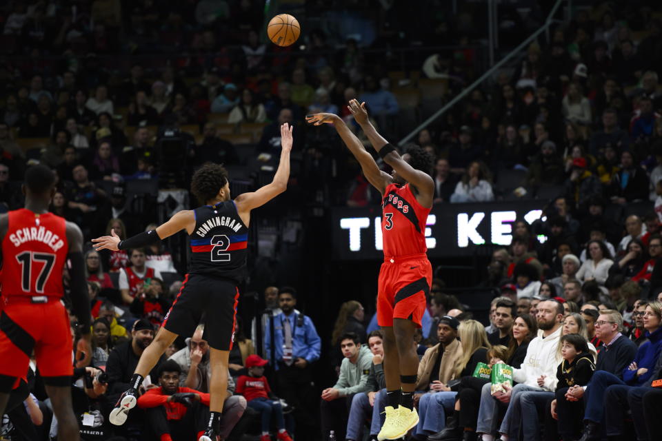 Toronto Raptors forward O.G. Anunoby (3) shoots a 3-pointer over Detroit Pistons guard Cade Cunningham (2) during the first half of an NBA basketball game in Toronto on Sunday, Nov. 19, 2023. (Christopher Katsarov/The Canadian Press via AP)
