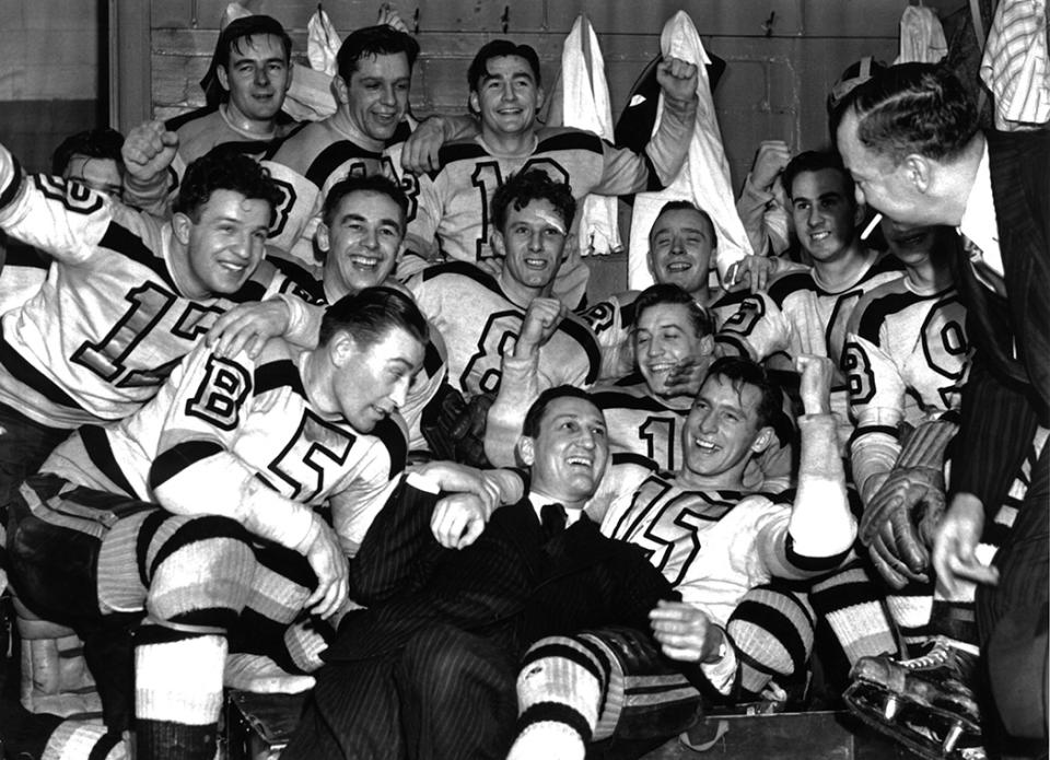 <p>DETROIT, MI – APRIL 12: The Boston Bruins celebrate in the locker room with coach Cooney Weiland and general manager Art Ross (both in suits) after Game 4 of the 1941 Stanley Cup Finals against the Detroit Red Wings on April 12, 1941 at the Olympia Stadium in Detroit, Michigan. The players are Bobby Bauer #17, Dit Clapper #5, Milt Schmidt #15, Roy Conacher #9, Herb Cain #4, Des Smith #8, Terry Reardon #19, Mel Hill #16 and Woody Dumart #14. (Photo by B Bennett/Bruce Bennett Studios/Getty Images) </p>