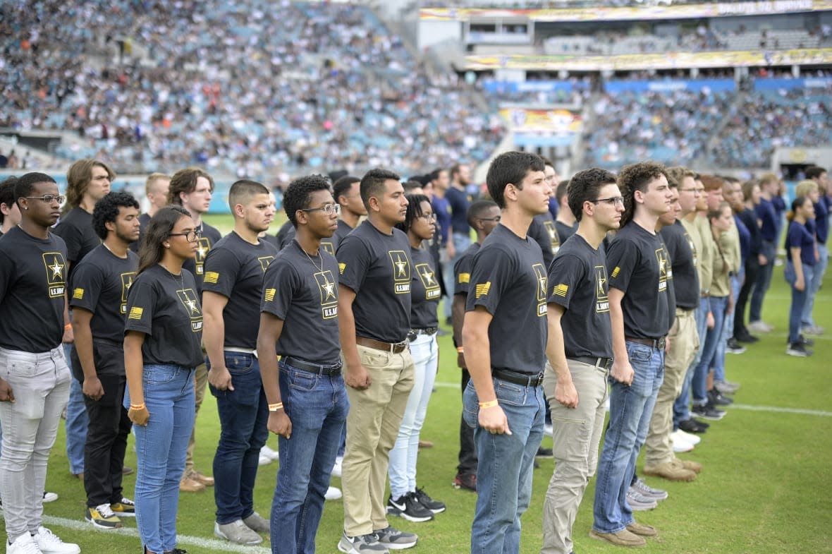 Military recruits are sworn in during halftime on Salute to Service military appreciation day at an NFL football game between the Jacksonville Jaguars and the Las Vegas Raiders, Nov. 6, 2022, in Jacksonville, Fla. (AP Photo/Phelan M. Ebenhack, File)