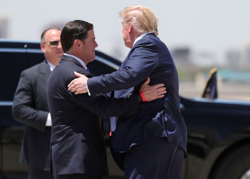 FILE PHOTO: U.S. President Trump hugs Arizona Governor Doug Ducey as he arrives in Phoenix, Arizona