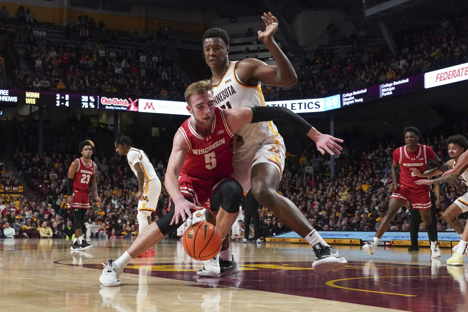 Wisconsin forward Tyler Wahl (5) drives past Minnesota forward Pharrel Payne during the second half of an NCAA college basketball game Tuesday, Jan. 23, 2024, in Minneapolis. (AP Photo/Craig Lassig)