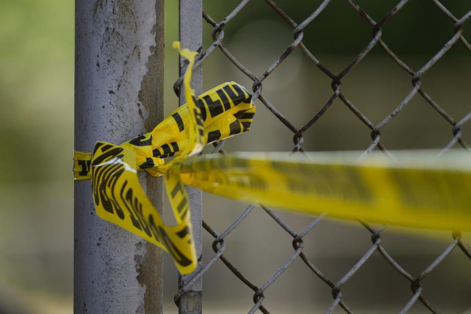 Police tape cordons off the scene of a fatal shooting at Delaware County Linen in Chester, Pa., Wednesday, May 22, 2024. Authorities say a former employee armed with a handgun opened fire at a linen company in a Philadelphia suburb, killing multiple people and wounding three others. (AP Photo/Matt Rourke)