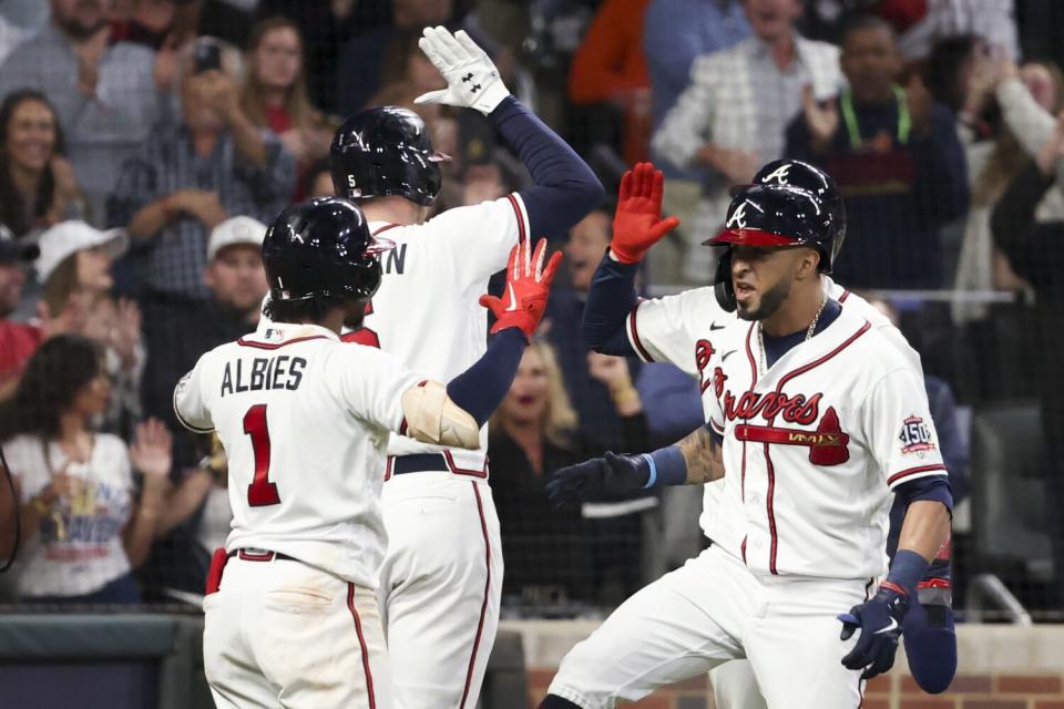 Braves' Eddie Rosario, right, celebrates