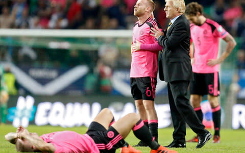 Gordon Strachan consoles Scotland's players - Credit: AP
