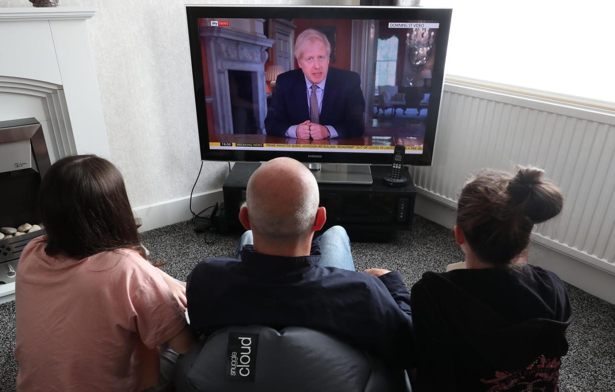 People in a house in Liverpool watch Prime Minister Boris Johnson addressing the nation about coronavirus (COVID-19) from 10 Downing Street, London.