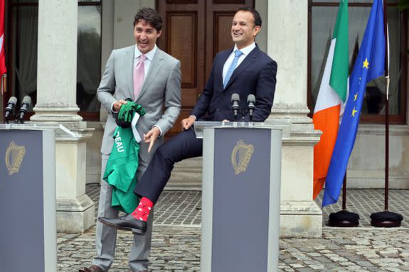 Justin Trudeau is presented with an Ireland rugby union shirt and a pair of socks by Ireland's Prime Minister Leo Varadkar.