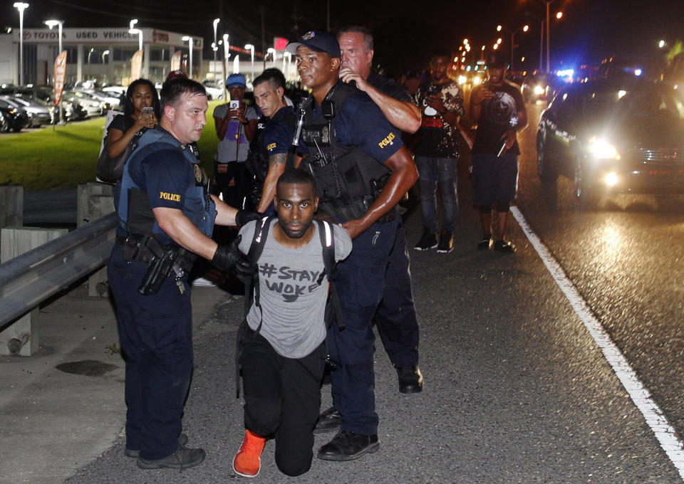 FILE - In this Saturday, July 9, 2016 file photo, police officers arrest activist DeRay McKesson during a protest along Airline Highway, a major road that passes in front of the Baton Rouge Police Department headquarters in Baton Rouge, La., after the fatal shooting of Alton Sterling by two white Baton Rouge police officers. OurStates.org, a new initiative launched by Black Lives Matter activists is trying to re-focus the movement’s efforts to state capitols, building on the momentum at the federal level to push back against President Donald Trump’s political agenda, targeting legislation on issues like policing and immigration. (AP Photo/Max Becherer, File)